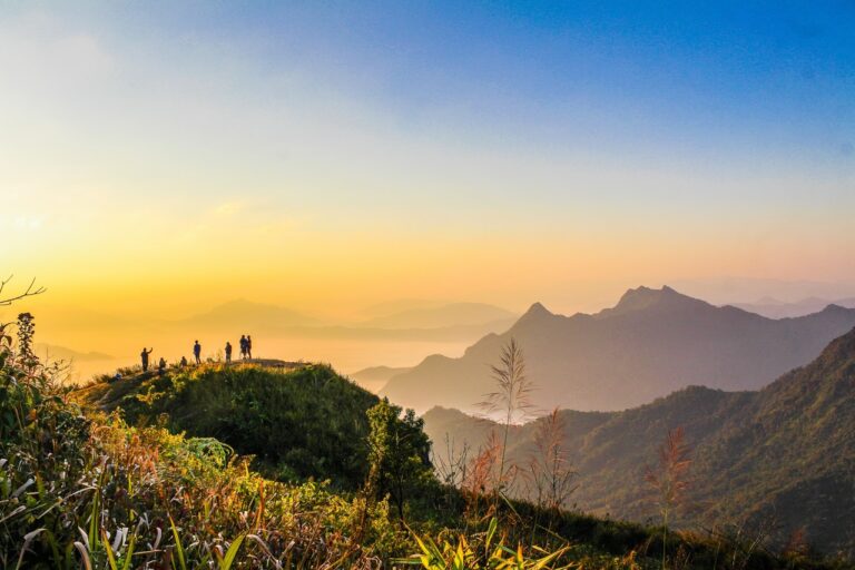photo of people standing on top of mountain near grasses 733162.jpg
